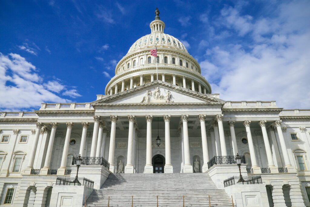 The image shows the United States Capitol building in Washington, D.C., featuring