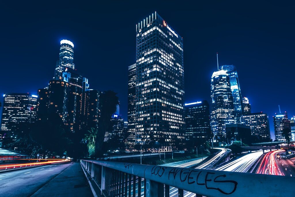 Night view of a bustling city skyline with illuminated skyscrapers, reminiscent